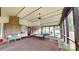 Versatile sunroom with a brick wall, seating, and an inviting outdoor view at 7626 Surreywood Pl, Charlotte, NC 28270