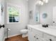 Well lit bathroom with a white vanity, stylish mirror, and modern fixtures at 7822 Noland Woods Dr, Charlotte, NC 28277