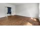 An empty room boasting hardwood floors, natural light, and versatile space for customization at 7822 Noland Woods Dr, Charlotte, NC 28277