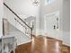 Bright foyer with hardwood floors and a staircase, creating a grand entrance and open feel at 7822 Noland Woods Dr, Charlotte, NC 28277