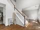 Bright foyer with hardwood floors and a staircase, creating a grand entrance and open feel at 7822 Noland Woods Dr, Charlotte, NC 28277