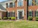 Close up showing a front door with black shutters and flower pots, adding a touch of elegance to the facade at 7822 Noland Woods Dr, Charlotte, NC 28277