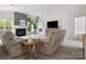 Inviting living room with comfortable seating, fireplace, and abundant natural light, perfect for relaxation at 7822 Noland Woods Dr, Charlotte, NC 28277
