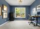 Office with a large window, neutral carpet, and classic paint, creating a comfortable workspace at 7822 Noland Woods Dr, Charlotte, NC 28277