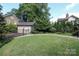 Large backyard with a two-car garage and mature trees, offering ample space for outdoor activities at 801 Berkeley Ave, Charlotte, NC 28203