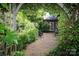 Secluded backyard patio featuring gravel, lush landscaping and outdoor seating at 801 Berkeley Ave, Charlotte, NC 28203