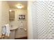 Charming bathroom with pedestal sink and shower with a black and white striped curtain at 801 Berkeley Ave, Charlotte, NC 28203