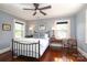 Comfortable bedroom featuring hardwood floors, two windows, and a ceiling fan at 801 Berkeley Ave, Charlotte, NC 28203
