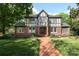 Charming Tudor-style home with brick facade, lush landscaping, and a welcoming brick walkway at 801 Berkeley Ave, Charlotte, NC 28203
