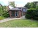 Charming brick home with a cozy covered front porch and beautifully landscaped front yard at 801 Berkeley Ave, Charlotte, NC 28203