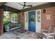 Inviting front porch with blue door, hanging swing, and brick exterior at 801 Berkeley Ave, Charlotte, NC 28203