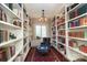 Cozy library with floor-to-ceiling bookshelves, a comfortable chair, and a patterned rug for a relaxed ambiance at 801 Berkeley Ave, Charlotte, NC 28203