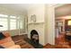 Comfortable living room with a fireplace, a view of the yard, and hardwood floors at 801 Berkeley Ave, Charlotte, NC 28203