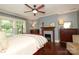 Tranquil bedroom featuring hardwood floors, a decorative fireplace, and plenty of natural light from the windows at 801 Berkeley Ave, Charlotte, NC 28203
