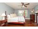 Spacious bedroom with hardwood floors, a ceiling fan, and natural light streaming through the large windows at 801 Berkeley Ave, Charlotte, NC 28203
