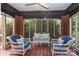 Relaxing sunroom with brick accents, tiled floor, and comfortable wicker seating at 801 Berkeley Ave, Charlotte, NC 28203