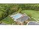 Community pool with a clubhouse and cabanas surrounded by lush trees and parking at 801 Celbridge Ct, Charlotte, NC 28270