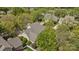 Aerial view of a home surrounded by mature trees, lush landscaping, and a white picket fence at 801 Celbridge Ct, Charlotte, NC 28270