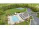Community pool with a clubhouse, cabanas, and adjacent tennis courts surrounded by lush trees and parking at 801 Celbridge Ct, Charlotte, NC 28270