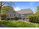 A beautifully landscaped backyard featuring a brick patio with outdoor seating and lush green grass at 801 Celbridge Ct, Charlotte, NC 28270