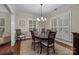 Bright dining room showcasing plantation shutters, hardwood floors, and a classic wood table at 801 Celbridge Ct, Charlotte, NC 28270