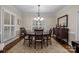 Elegant dining room featuring a classic chandelier, hardwood floors, and ample seating at 801 Celbridge Ct, Charlotte, NC 28270