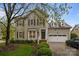 Charming two-story home with well-manicured landscaping, inviting entryway and attached two car garage at 801 Celbridge Ct, Charlotte, NC 28270