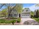 Charming two-story home with a well-manicured lawn, beautiful shrubbery, white trimmed windows, and a two-car garage at 801 Celbridge Ct, Charlotte, NC 28270