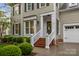 Inviting home entrance with a brick stairway, white railings, and a green front door with decorative wreath at 801 Celbridge Ct, Charlotte, NC 28270