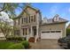 Charming two-story home with a well-manicured lawn, beautiful shrubbery, white trimmed windows, and a two-car garage at 801 Celbridge Ct, Charlotte, NC 28270