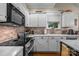 Well-lit kitchen features stainless steel appliances, white cabinets, and modern countertops at 801 Celbridge Ct, Charlotte, NC 28270