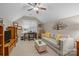 Cozy living room with a ceiling fan, decorative tree art, modern sofa, and a bright window with a workspace at 801 Celbridge Ct, Charlotte, NC 28270