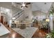 Open living room featuring hardwood floors, neutral decor, and seamless access to the kitchen and dining areas at 801 Celbridge Ct, Charlotte, NC 28270