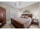 Comfortable main bedroom featuring a king-size bed, ceiling fan, and a window at 801 Celbridge Ct, Charlotte, NC 28270