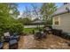 Charming brick patio with seating area, grill, and lush greenery for outdoor enjoyment at 801 Celbridge Ct, Charlotte, NC 28270