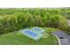 Aerial view of two well-maintained tennis courts surrounded by lush trees with an adjacent parking lot at 801 Celbridge Ct, Charlotte, NC 28270