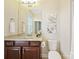 A well-lit half bathroom features modern vanity, sink and fixtures and neutral wall color at 8618 Whitehawk Hill Rd, Waxhaw, NC 28173