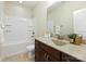 Bright bathroom featuring a granite-topped vanity and tiled floor, complemented by a separate toilet and tub space at 8618 Whitehawk Hill Rd, Waxhaw, NC 28173