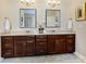 Bathroom features a double vanity, granite countertops, and decorative mirrors at 8618 Whitehawk Hill Rd, Waxhaw, NC 28173
