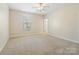 Bright bedroom with neutral carpet, a ceiling fan, and a window offering natural light, creating a peaceful ambiance at 8618 Whitehawk Hill Rd, Waxhaw, NC 28173