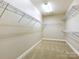 Walk-in closet with wire shelving and carpeted floors, providing ample storage space at 8618 Whitehawk Hill Rd, Waxhaw, NC 28173