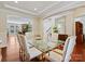 Elegant dining room with hardwood floors, arched entryway and a modern glass-top dining table at 8618 Whitehawk Hill Rd, Waxhaw, NC 28173