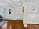 Inviting foyer featuring hardwood floors, neutral paint, a stylish mirror and bright natural light at 8618 Whitehawk Hill Rd, Waxhaw, NC 28173