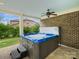 Covered outdoor hot tub and patio with brick and ceiling fan, perfect for relaxation and entertaining at 8618 Whitehawk Hill Rd, Waxhaw, NC 28173