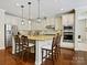 Bright kitchen features a large island with seating, stainless steel appliances, and custom cabinetry at 8618 Whitehawk Hill Rd, Waxhaw, NC 28173