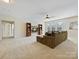 Spacious living room featuring a large sectional sofa, ceiling fan, and built-in shelving at 8618 Whitehawk Hill Rd, Waxhaw, NC 28173