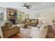 Comfortable living room with a stone fireplace, a ceiling fan and plenty of natural light at 8618 Whitehawk Hill Rd, Waxhaw, NC 28173