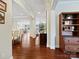 Open-concept living area with hardwood floors and elegant archways leading to the dining and living spaces at 8618 Whitehawk Hill Rd, Waxhaw, NC 28173