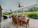 Covered outdoor patio featuring a wooden dining set and ceiling fans, ideal for outdoor meals at 8618 Whitehawk Hill Rd, Waxhaw, NC 28173