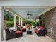 Inviting covered patio with comfortable seating, ceiling fans, and an adjacent outdoor dining area at 8618 Whitehawk Hill Rd, Waxhaw, NC 28173